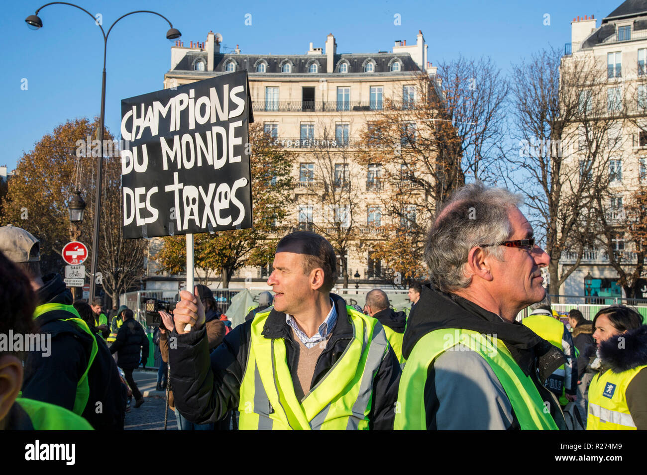 A protester seen holding a placard during the protest. People demonstrated in yellow vests against the increase of fuel prices in Paris, France. Stock Photo