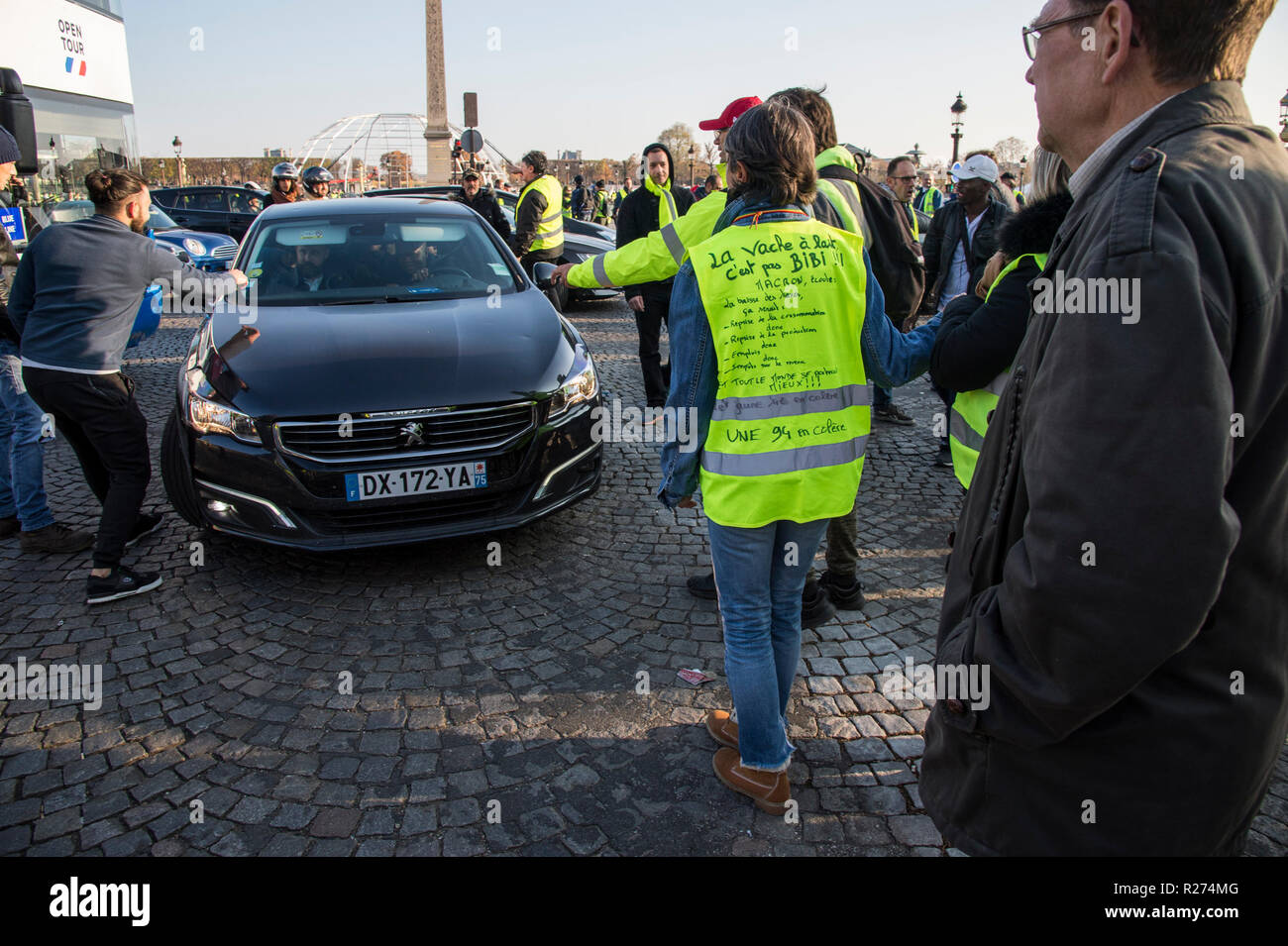 Protesters are seen stopping a vehicle during the protest. People demonstrated in yellow vests against the increase of fuel prices in Paris, France. Stock Photo