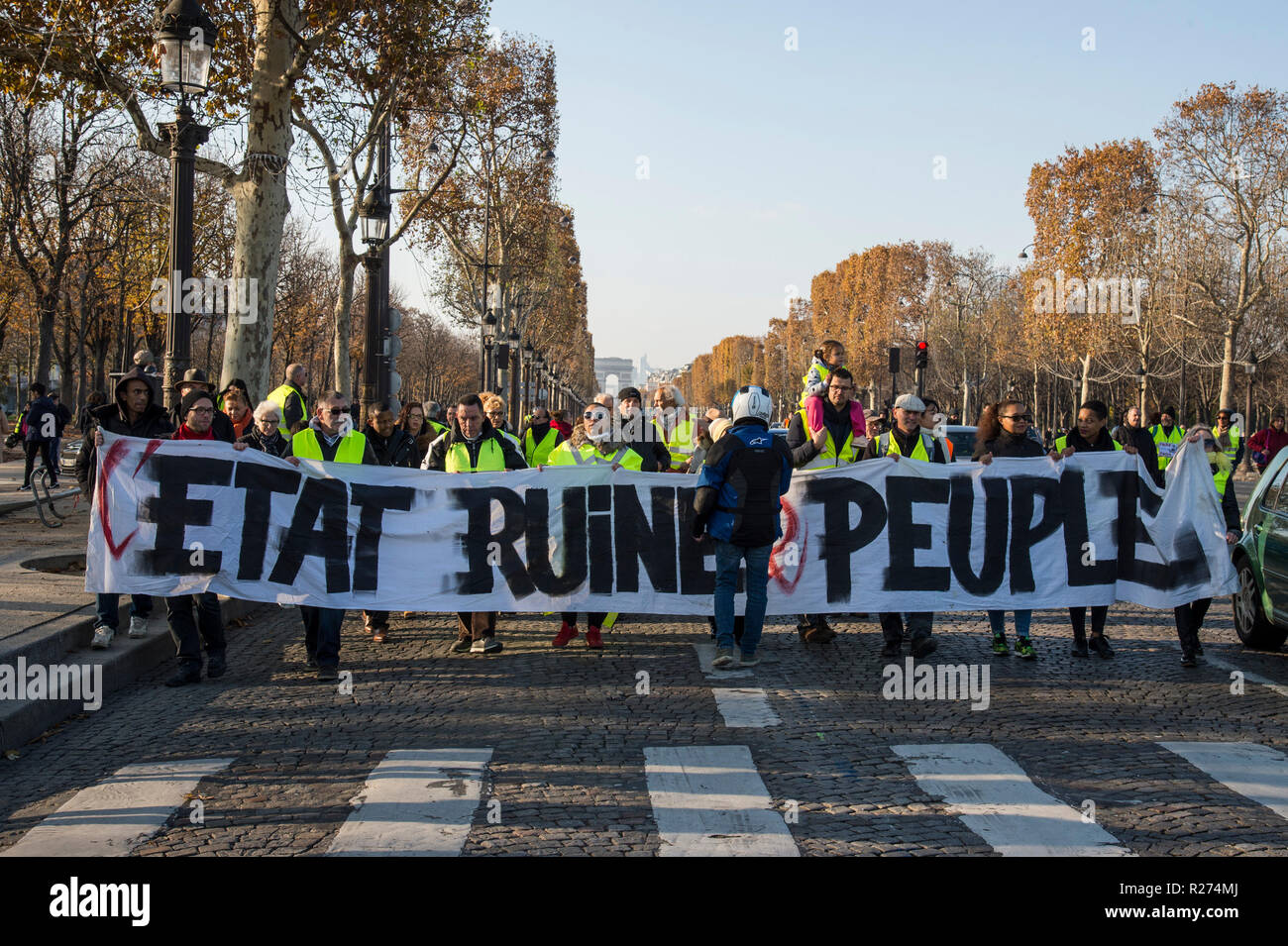 Protesters wearing yellow vests are seen holding a banner during the protest. People demonstrated in yellow vests against the increase of fuel prices in Paris, France. Stock Photo