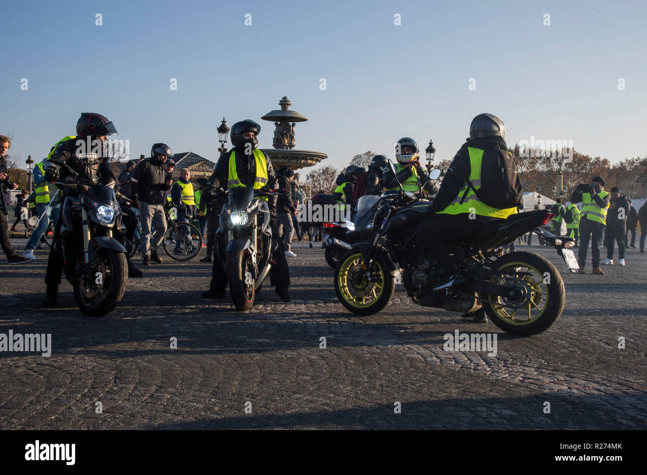 Protesters wearing yellow vests are seen on the street riding motorcycles during the protest. People demonstrated in yellow vests against the increase of fuel prices in Paris, France. Stock Photo