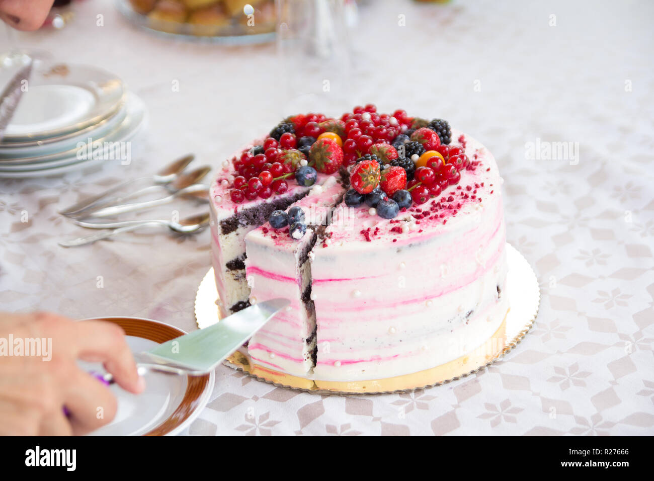 hand serving birthday cake Stock Photo