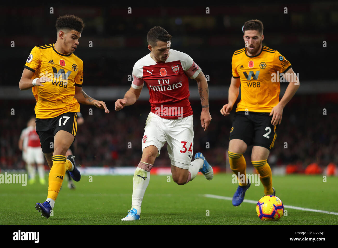 Granit Xhaka of Arsenal gets in between Morgan Gibbs-White and Matt Doherty of Wolverhampton Wanderers- Arsenal v Wolverhampton Wanderers, Premier Lea Stock Photo