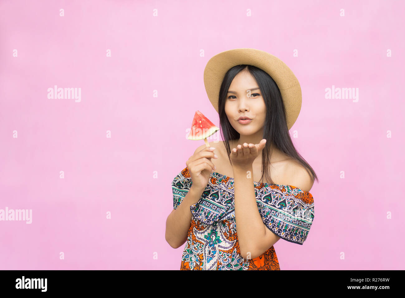 portrait of beautiful asian woman with watermelon isolated on pink background. summer and vacations Stock Photo