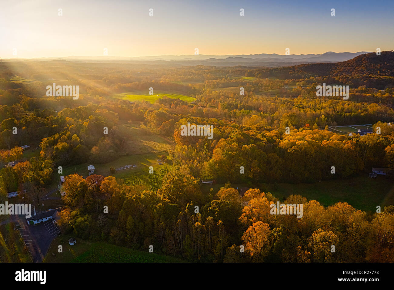 Aerial view of golden hour sunset in Mountains with sun rays