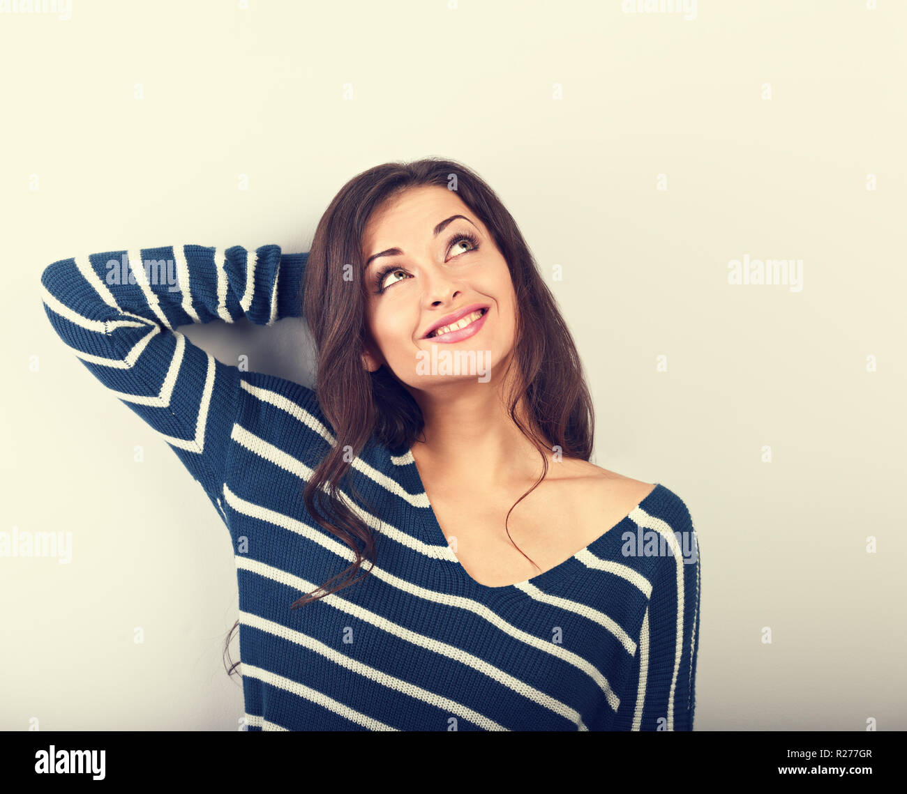 Beautiful Thinking Natural Toothy Smiling Woman Looking Up In Warm