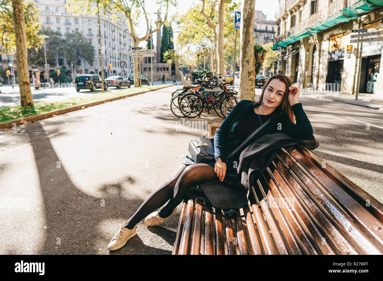 beautiful girl sitting on a bench in the park in europe Stock Photo - Alamy