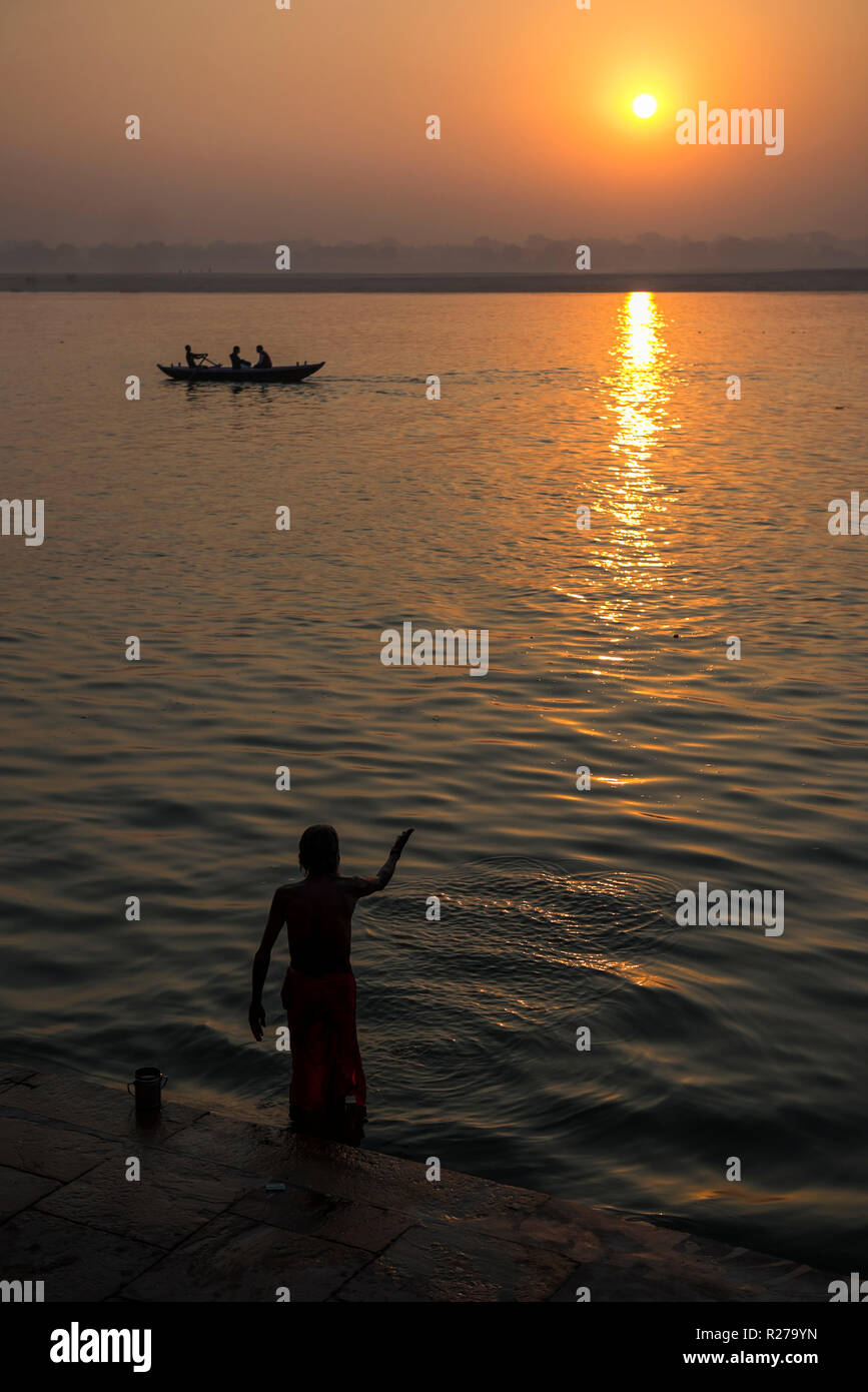 Morning Ritual And Washing At Sunrise Along The Banks Of The River Ganges In Varanasi India