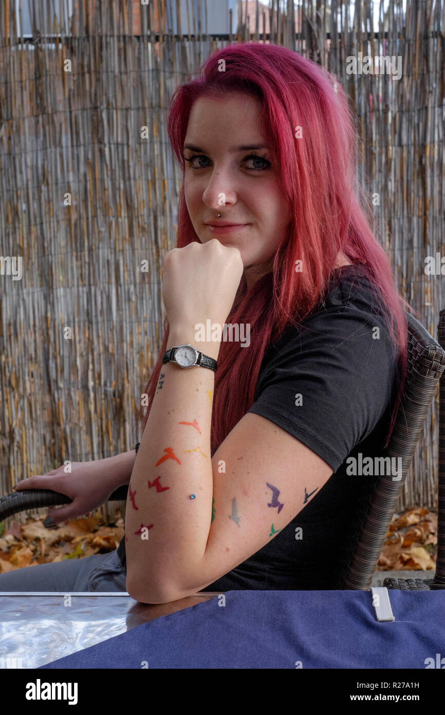 portrait of a smiling young female with red dyed hair and bats tattooed on her arm lenti zala county hungary Stock Photo