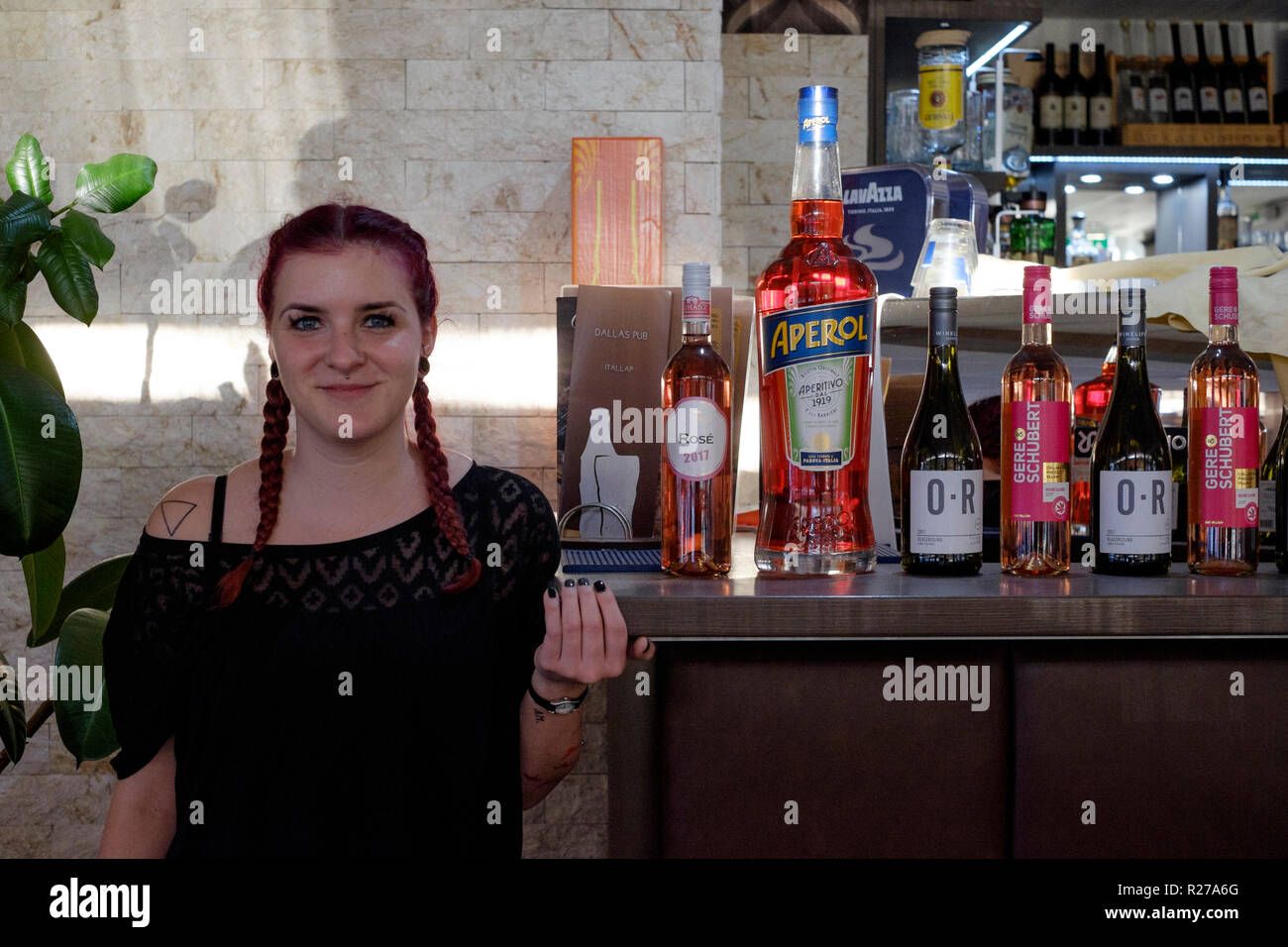 young female barmaid taking a break from work in the dallas bar lenti zala county hungary Stock Photo