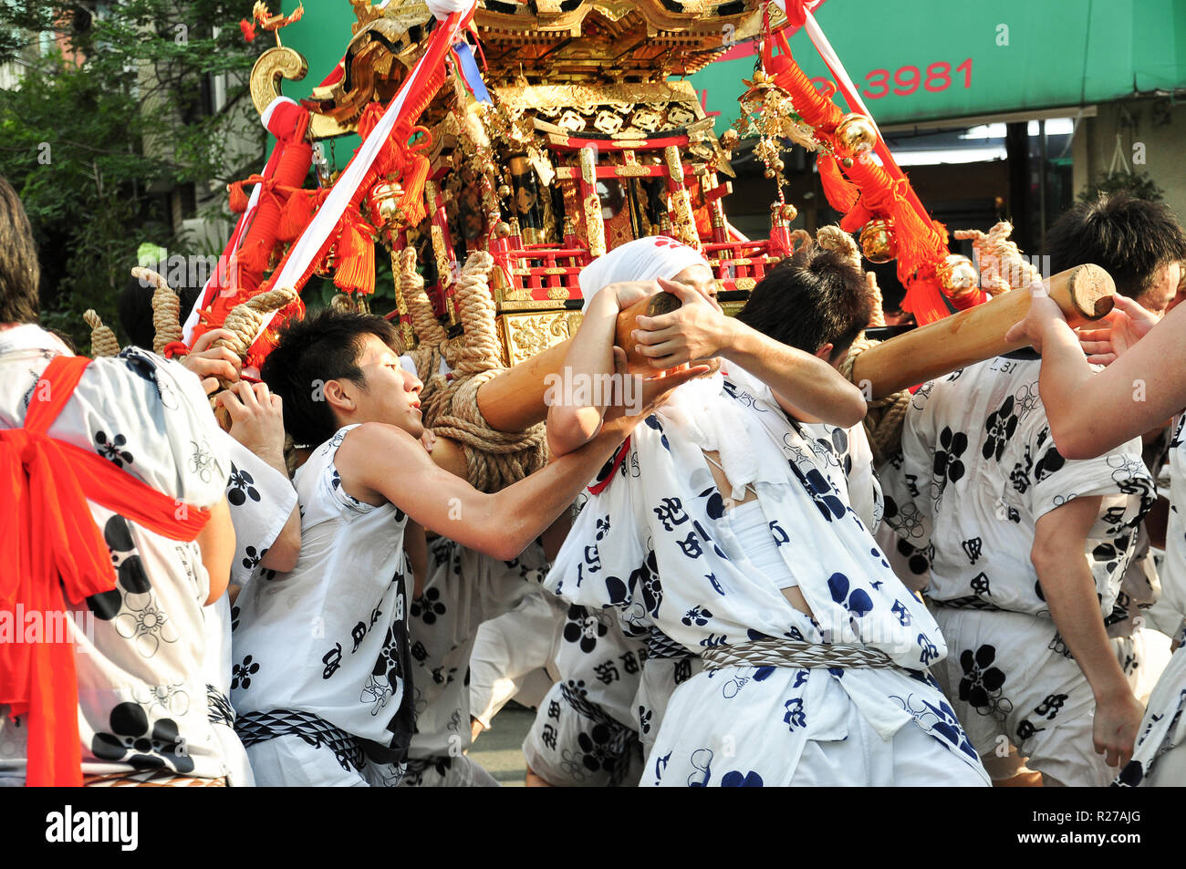 Tenjin Images Osaka, Japan - July 25, 2012: Golden portable shrine carried and ...