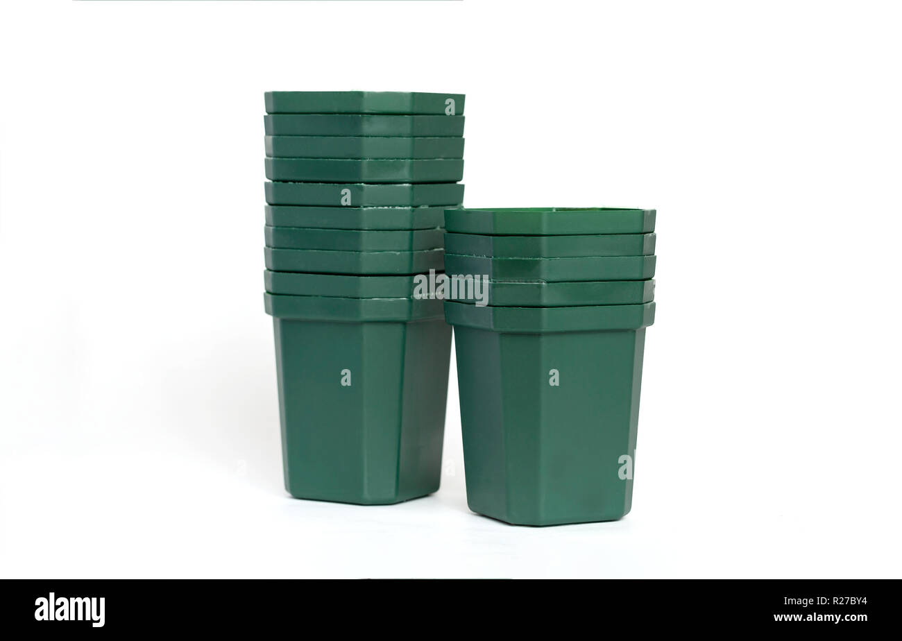 Empty plastic green flower pots isolated on white background. Stock Photo