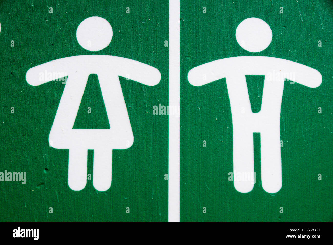 Public restroom toilet WC sign man and woman in green Stock Photo
