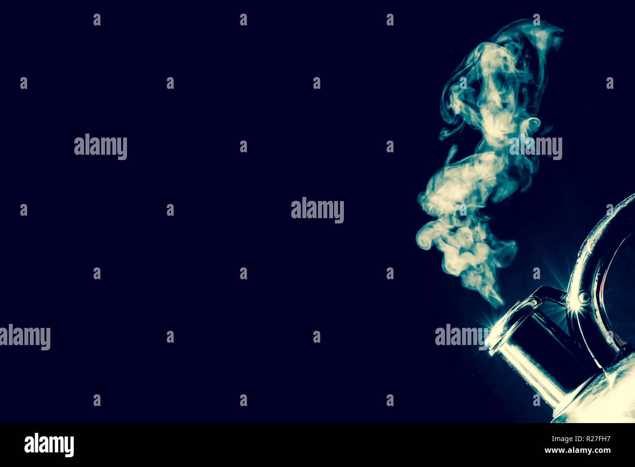 Kettle whistling, boiling kettle with steam texture on a black background. Vintage, grunge old