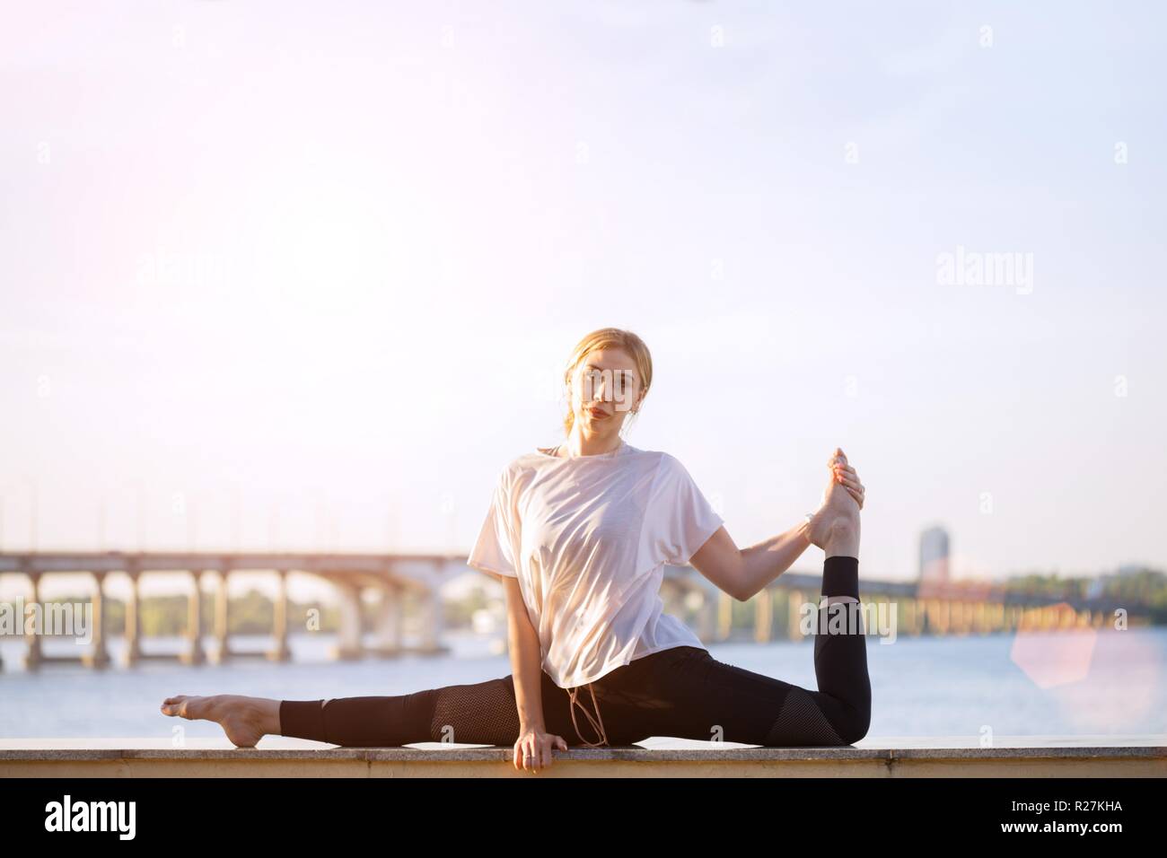 flexible little child girl in black sportswear perform transverse twine on  fly. Good stretching and gymnastics Stock Photo - Alamy