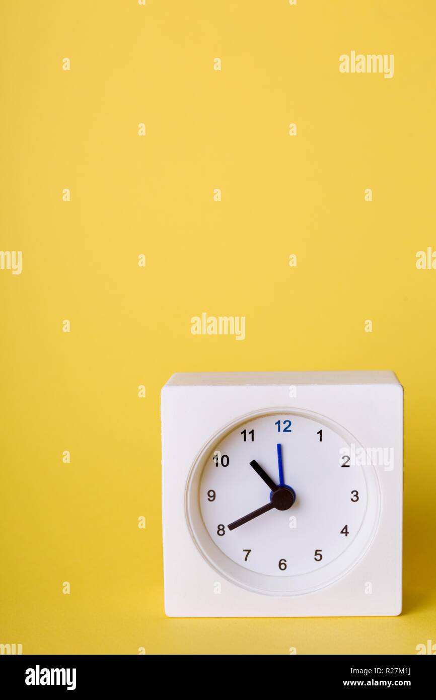 small square white clock on a blue background Stock Photo Alamy