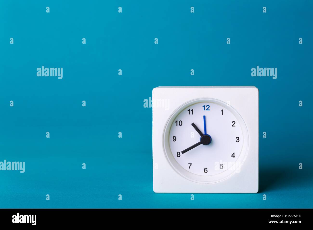 small square white clock on a yellow background Stock Photo Alamy