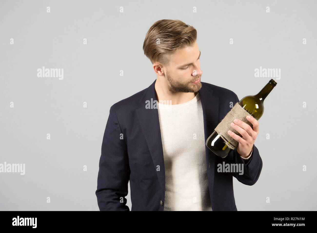 Nice choice. Man holds bottle alcohol drink. Social and cultural