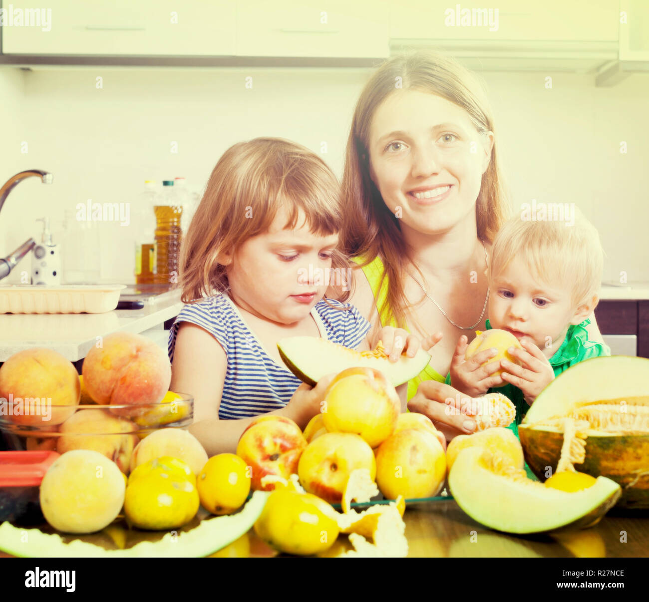 Parent and toddler eating melon hires stock photography and images Alamy
