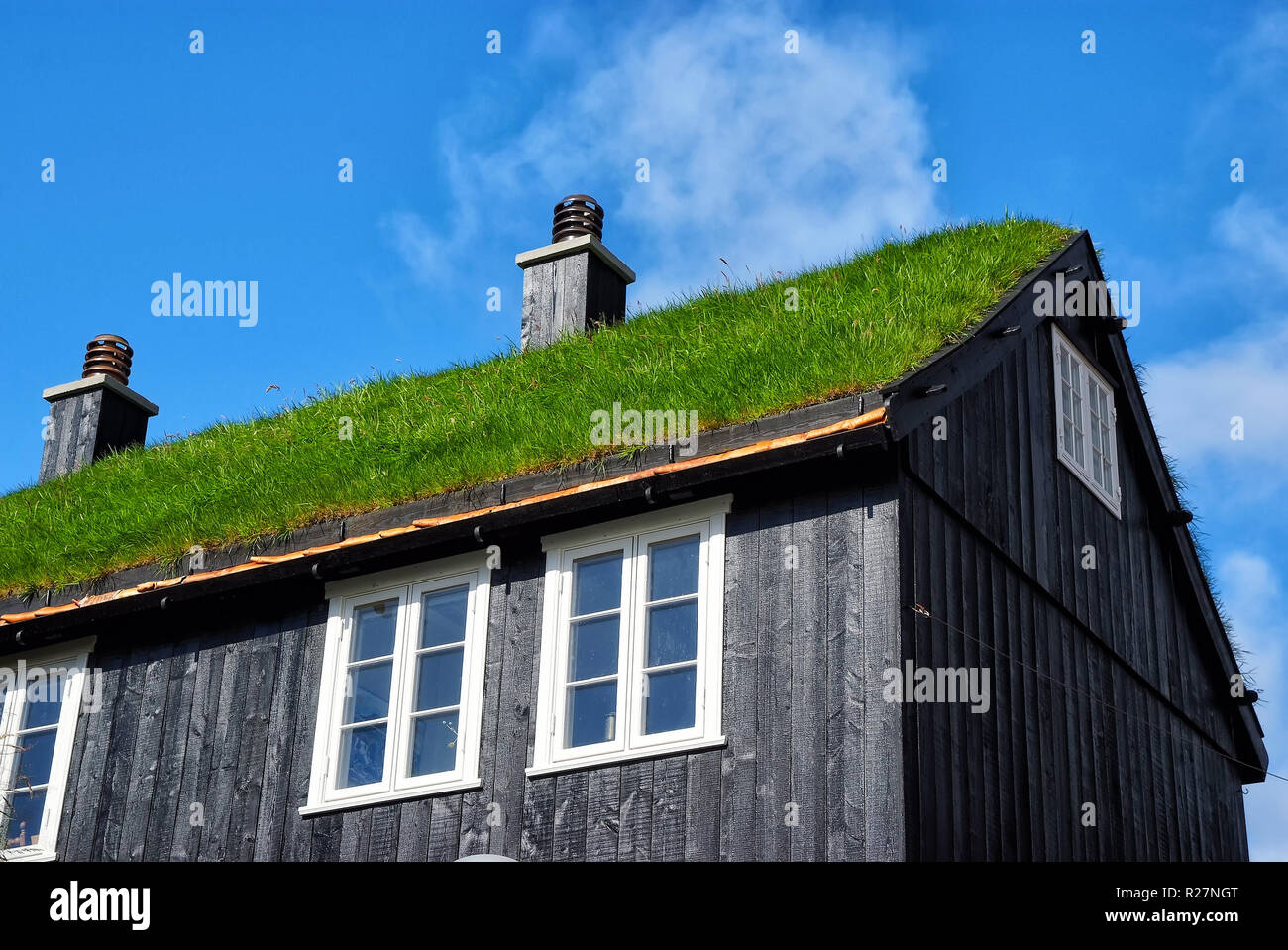 House with grass roof in Torshavn, Denmark. Eco friendly building. Architecture and design. Destination place. Ecology and environment. Summer vacation in countryside. Stock Photo