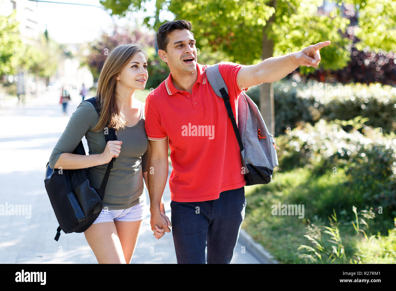 Happy couple is walking around park together outdoors Stock Photo - Alamy