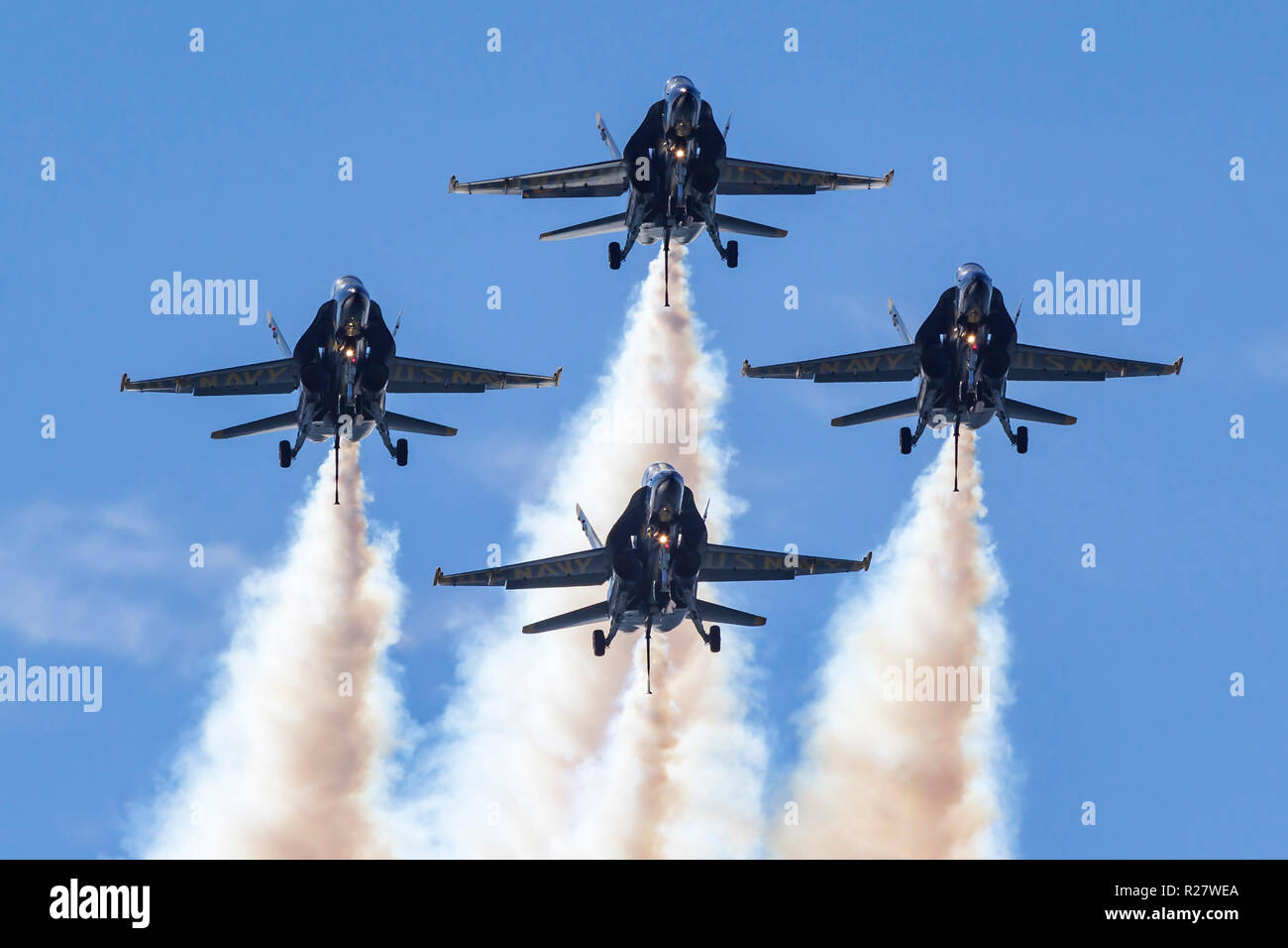 The Blue Angels diamond formation with gear down, tailhooks down, and smoke on approach the airshow box during a 2018 San Francisco Fleet Week perform Stock Photo