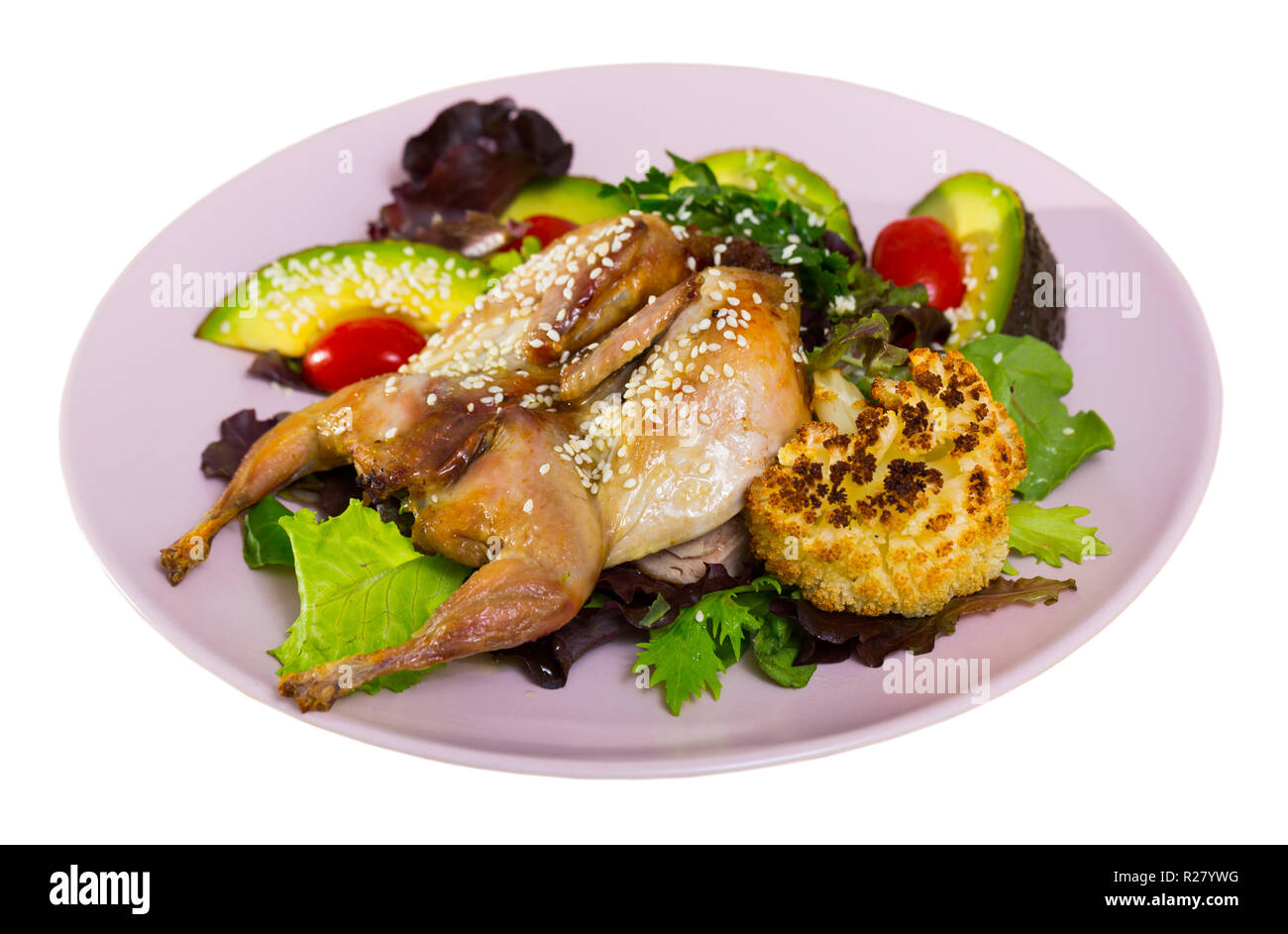 Fried quail-tobacco served with tasty with salad from avocado and fresh  greens. Isolated over white background Stock Photo
