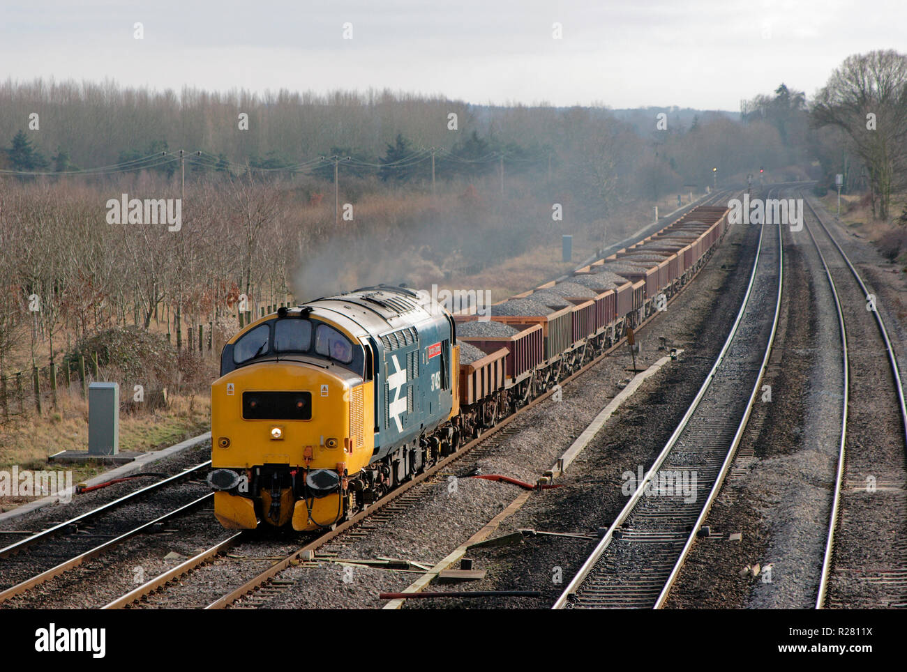 A class 37 diesel locomotive number 37425 in British Rail large logo livery working a loaded ballast train at Lower Basildon. Stock Photo