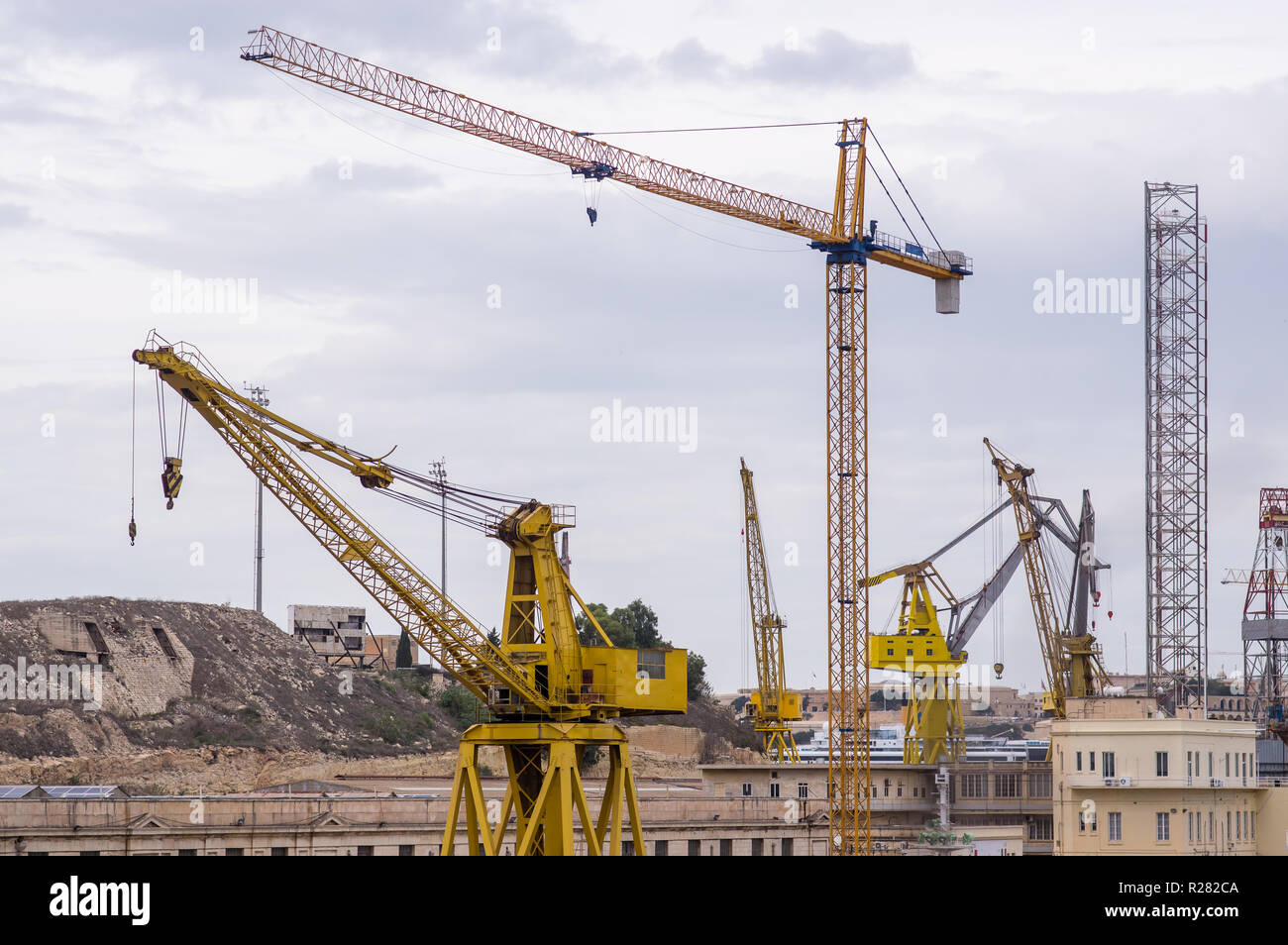 Yellow cranes in the port, Malta, Three cities Stock Photo