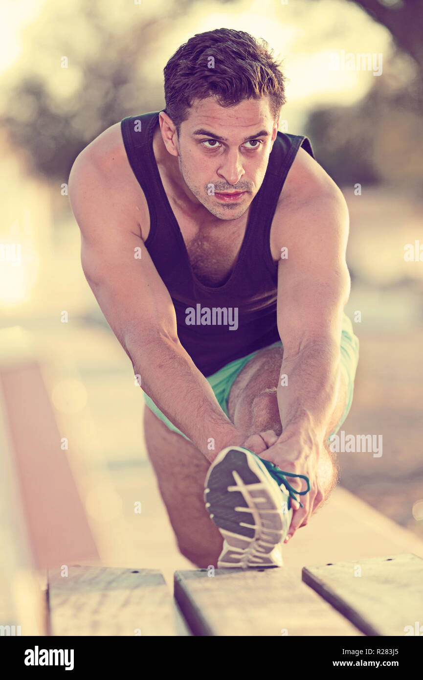 Stretching after workout on beach hires stock photography and images