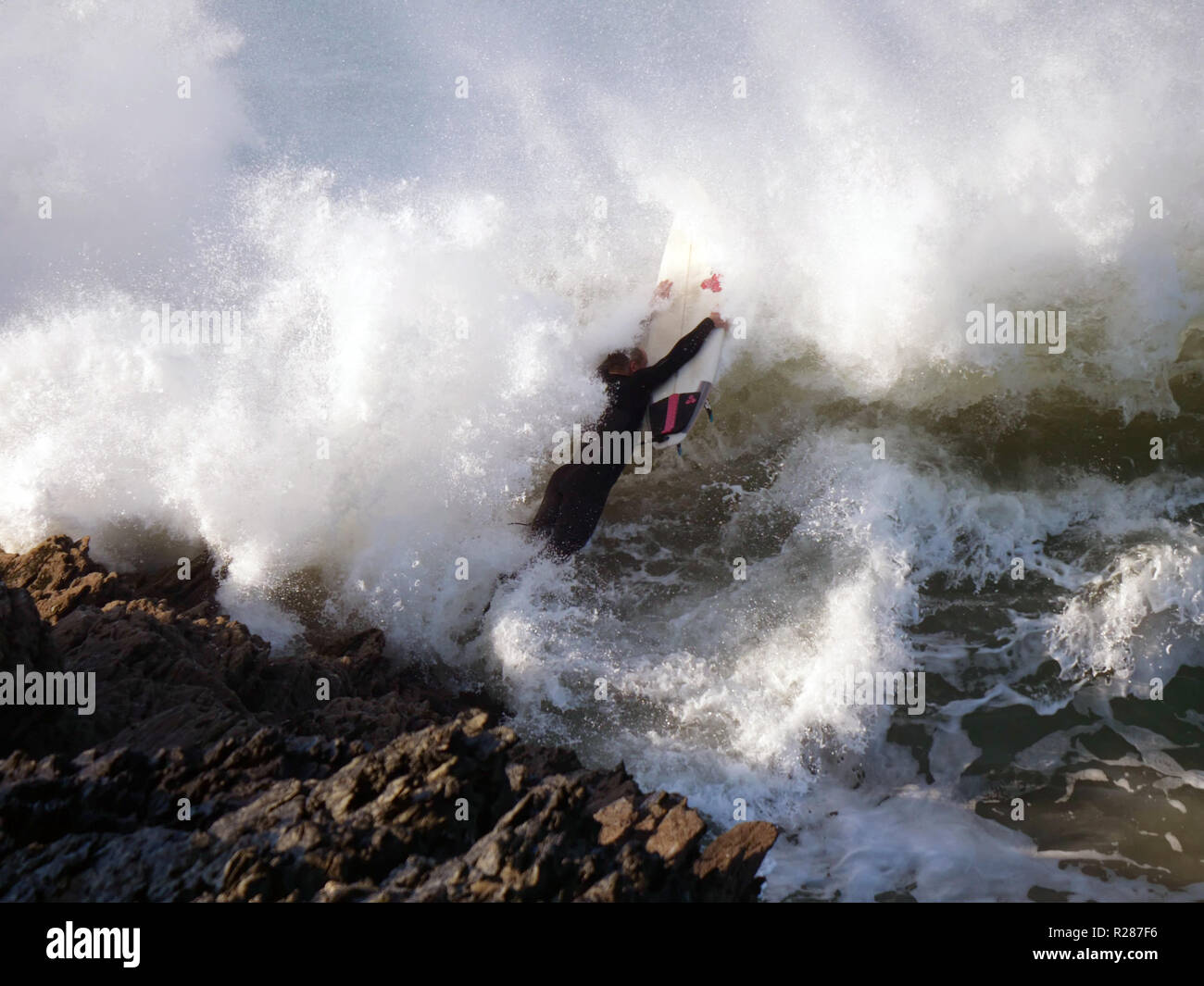 Big wave UK surfing and dangerous rocks Stock Photo Alamy