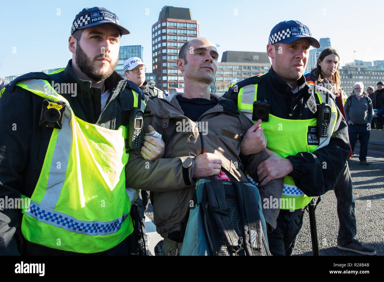 London, UK. 17th November, 2018. Police officers arrest a man after environmental campaigners from Extinction Rebellion blocked Lambeth Bridge, one of five bridges blocked in central London, as part of a Rebellion Day event to highlight 'criminal inaction in the face of climate change catastrophe and ecological collapse' by the UK Government as part of a programme of civil disobedience during which scores of campaigners have been arrested. Credit: Mark Kerrison/Alamy Live News Stock Photo