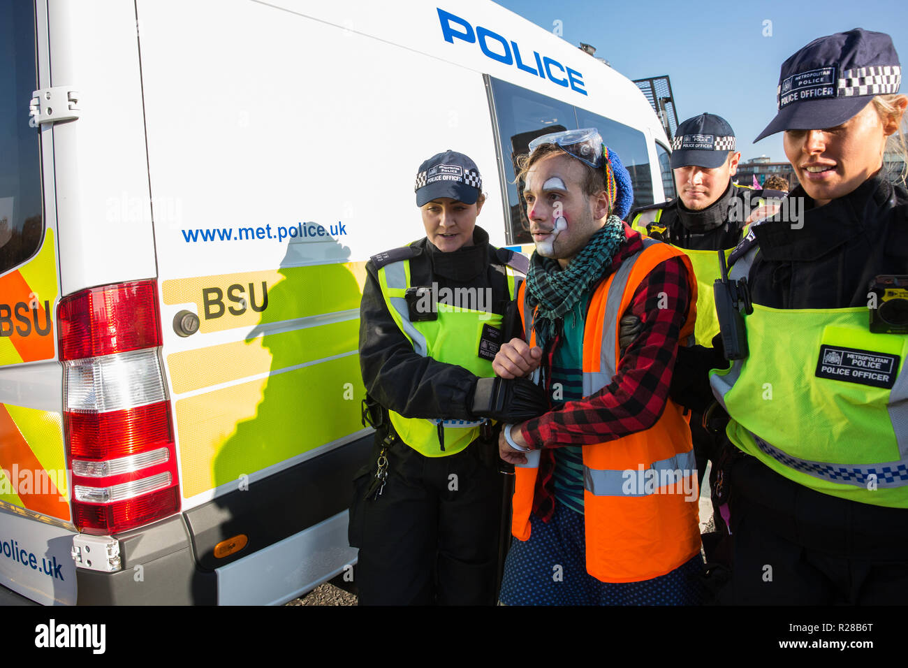 London, UK. 17th November, 2018. Police officers arrest a clown from Clandestine Insurgent Rebel Clown Army (CIRCA) after environmental campaigners from Extinction Rebellion blocked Lambeth Bridge, one of five bridges blocked in central London, as part of a Rebellion Day event to highlight 'criminal inaction in the face of climate change catastrophe and ecological collapse' by the UK Government as part of a programme of civil disobedience during which scores of campaigners have been arrested. Credit: Mark Kerrison/Alamy Live News Stock Photo