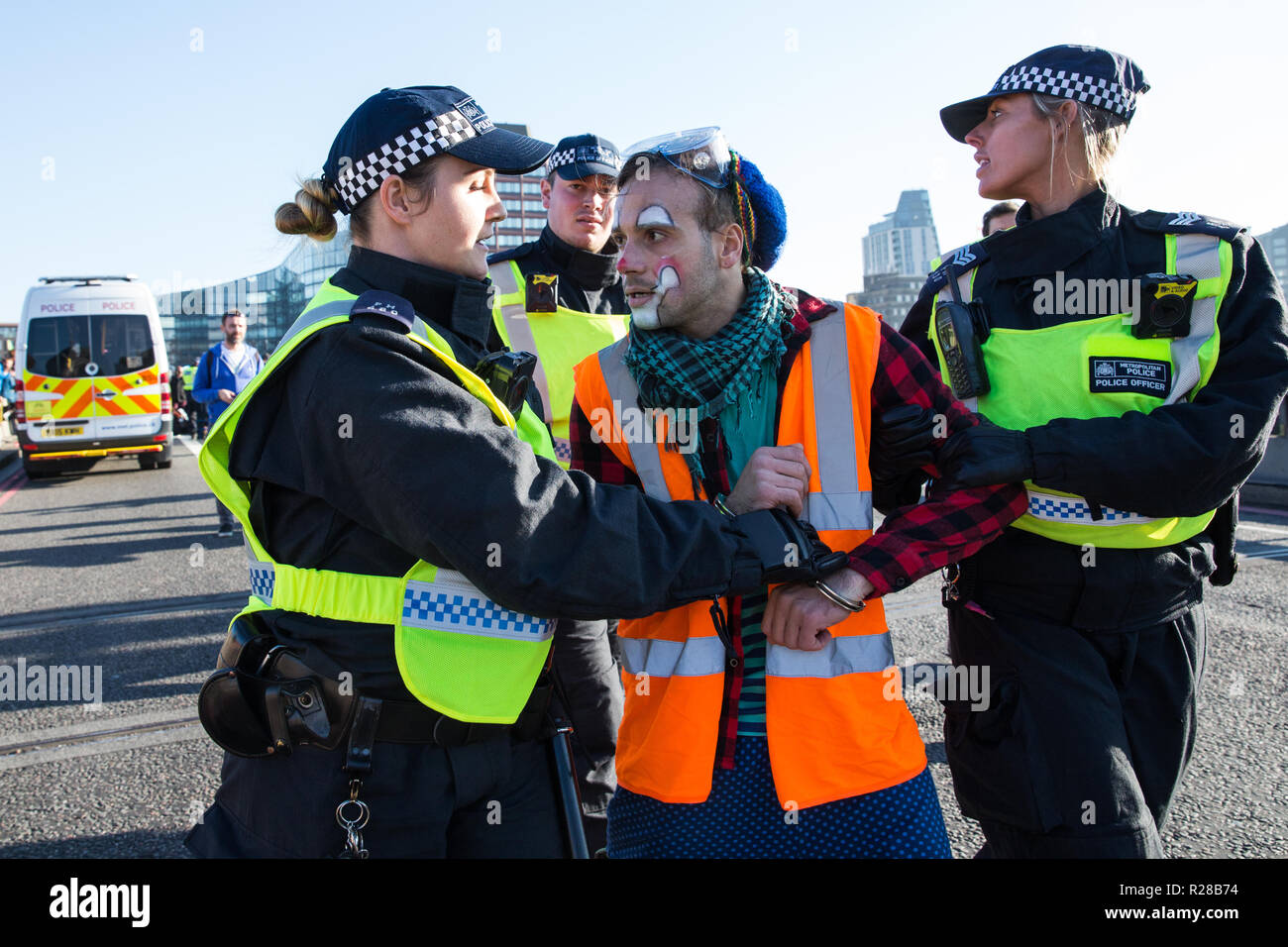 London, UK. 17th November, 2018. Police officers arrest a clown from Clandestine Insurgent Rebel Clown Army (CIRCA) after environmental campaigners from Extinction Rebellion blocked Lambeth Bridge, one of five bridges blocked in central London, as part of a Rebellion Day event to highlight 'criminal inaction in the face of climate change catastrophe and ecological collapse' by the UK Government as part of a programme of civil disobedience during which scores of campaigners have been arrested. Credit: Mark Kerrison/Alamy Live News Stock Photo