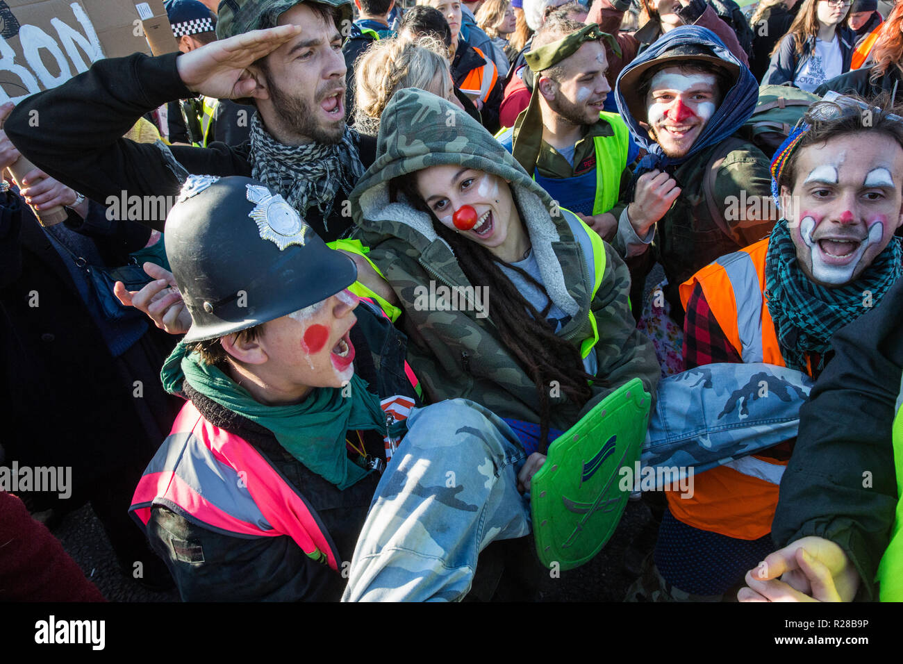 London, UK. 17th November, 2018police officers . Clowns from Clandestine Insurgent Rebel Clown Army (CIRCA) follow police officers arrestingt a man after environmental campaigners from Extinction Rebellion blocked Lambeth Bridge, one of five bridges blocked in central London, as part of a Rebellion Day event to highlight 'criminal inaction in the face of climate change catastrophe and ecological collapse' by the UK Government as part of a programme of civil disobedience during which scores of campaigners have been arrested. Credit: Mark Kerrison/Alamy Live News Stock Photo