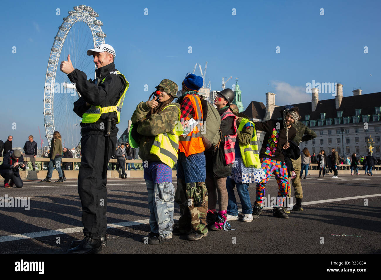 London, UK. 17th November, 2018. Clowns from Clandestine Insurgent Rebel Clown Army (CIRCA) support Extinction Rebellion blocking Westminster Bridge, one of five bridges blocked in central London, as part of a Rebellion Day event to highlight 'criminal inaction in the face of climate change catastrophe and ecological collapse' by the UK Government as part of a programme of civil disobedience during which scores of campaigners have been arrested. Credit: Mark Kerrison/Alamy Live News Stock Photo