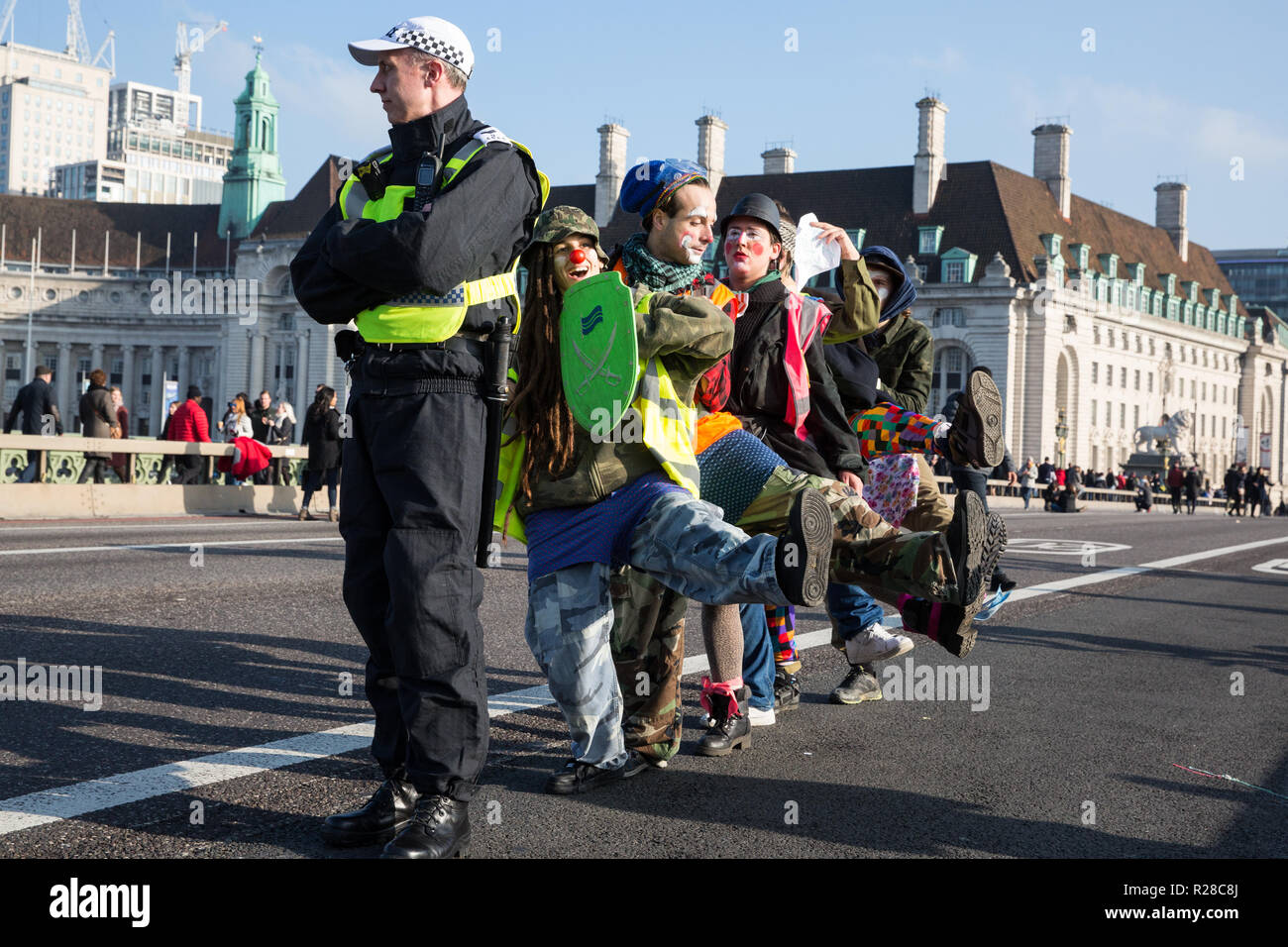 London, UK. 17th November, 2018. Clowns from Clandestine Insurgent Rebel Clown Army (CIRCA) support environmental campaigners from Extinction Rebellion blocking Westminster Bridge, one of five bridges blocked in central London, as part of a Rebellion Day event to highlight 'criminal inaction in the face of climate change catastrophe and ecological collapse' by the UK Government as part of a programme of civil disobedience during which scores of campaigners have been arrested. Credit: Mark Kerrison/Alamy Live News Stock Photo