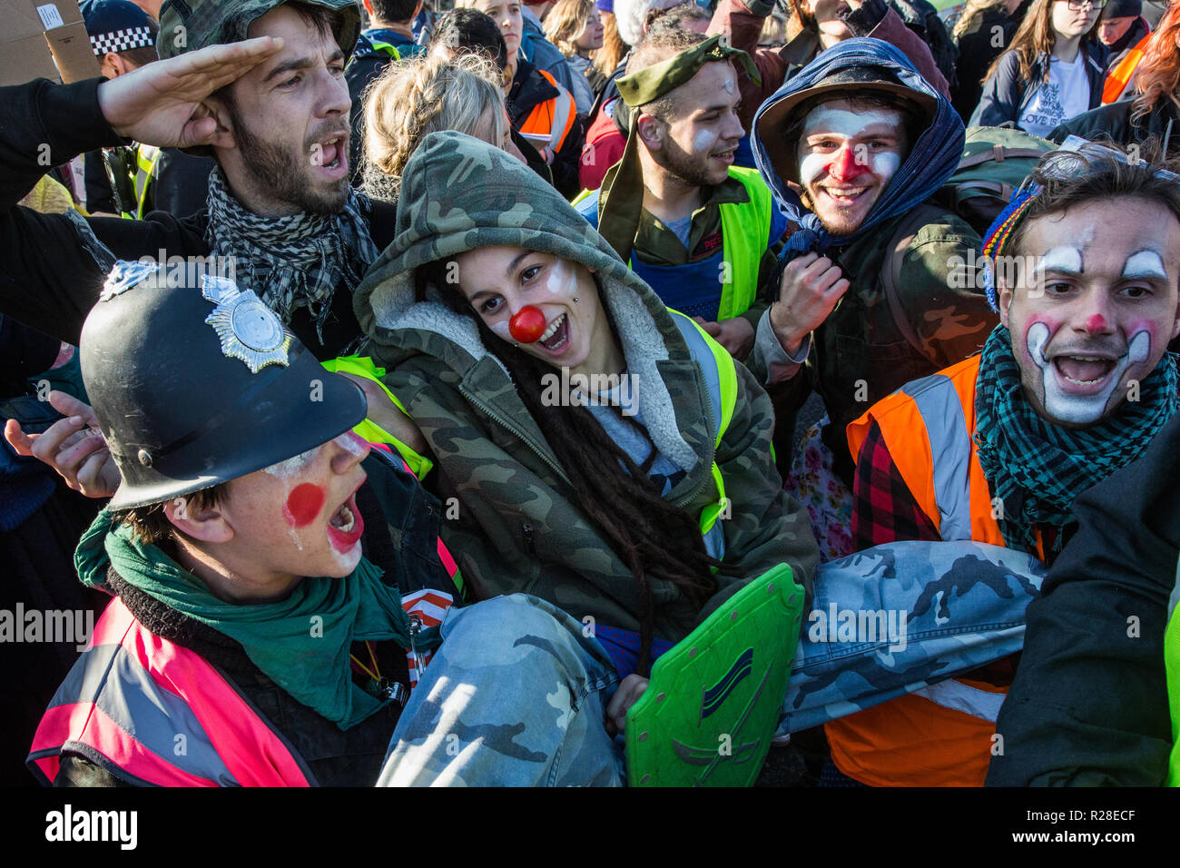 London, UK. 17th November, 2018. Clowns from Clandestine Insurgent Rebel Clown Army (CIRCA) mime a police arrest as they support environmental campaigners from Extinction Rebellion blocking Lambeth Bridge, one of five bridges blocked in central London, as part of a Rebellion Day event to highlight 'criminal inaction in the face of climate change catastrophe and ecological collapse' by the UK Government as part of a programme of civil disobedience during which scores of campaigners have been arrested. Credit: Mark Kerrison/Alamy Live News Stock Photo
