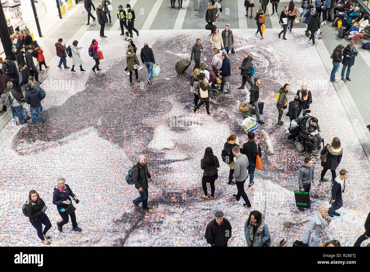 Birmingham, UK. 17th Nov, 2018. Twenty metre portrait of suffragette Hilda Burkitt at New Street Birmingham train station concourse.Artwork by artist Helen Marshall called Face of Suffrage,includes 3,724 photos from the public. Credit: Paul Quayle/Alamy Live News Stock Photo