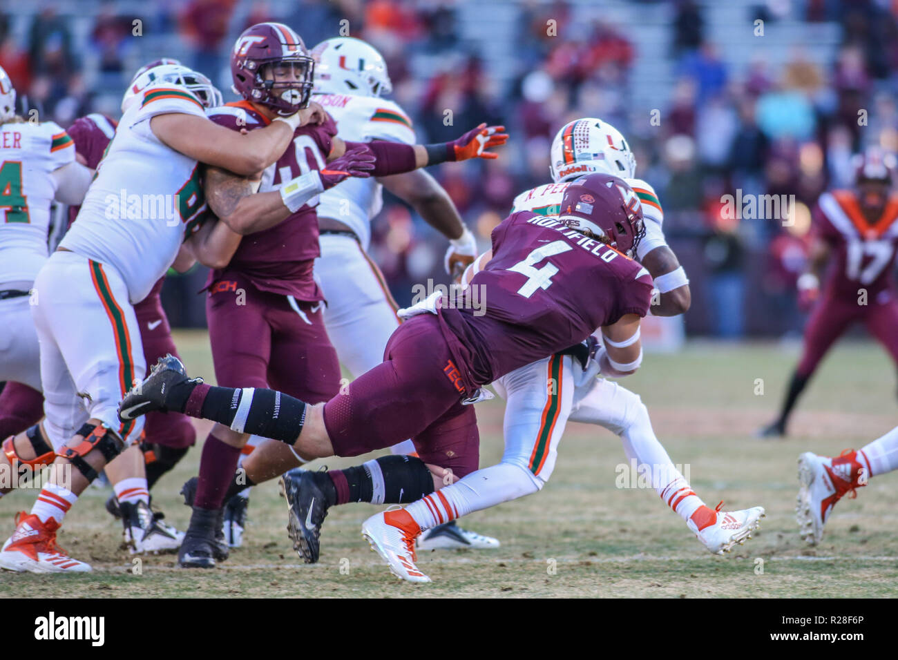 Blacksburg, VA, USA. 17th Nov, 2018. Virginia Tech Hokies linebacker Dax Hollifield (4) sacks Miami Hurricanes quarterback N'Kosi Perry (5) during NCAA football action between the Miami Hurricanes and the Virginia Tech Hokies at Lane Stadium in Blacksburg, VA. Jonathan Huff/CSM/Alamy Live News Stock Photo