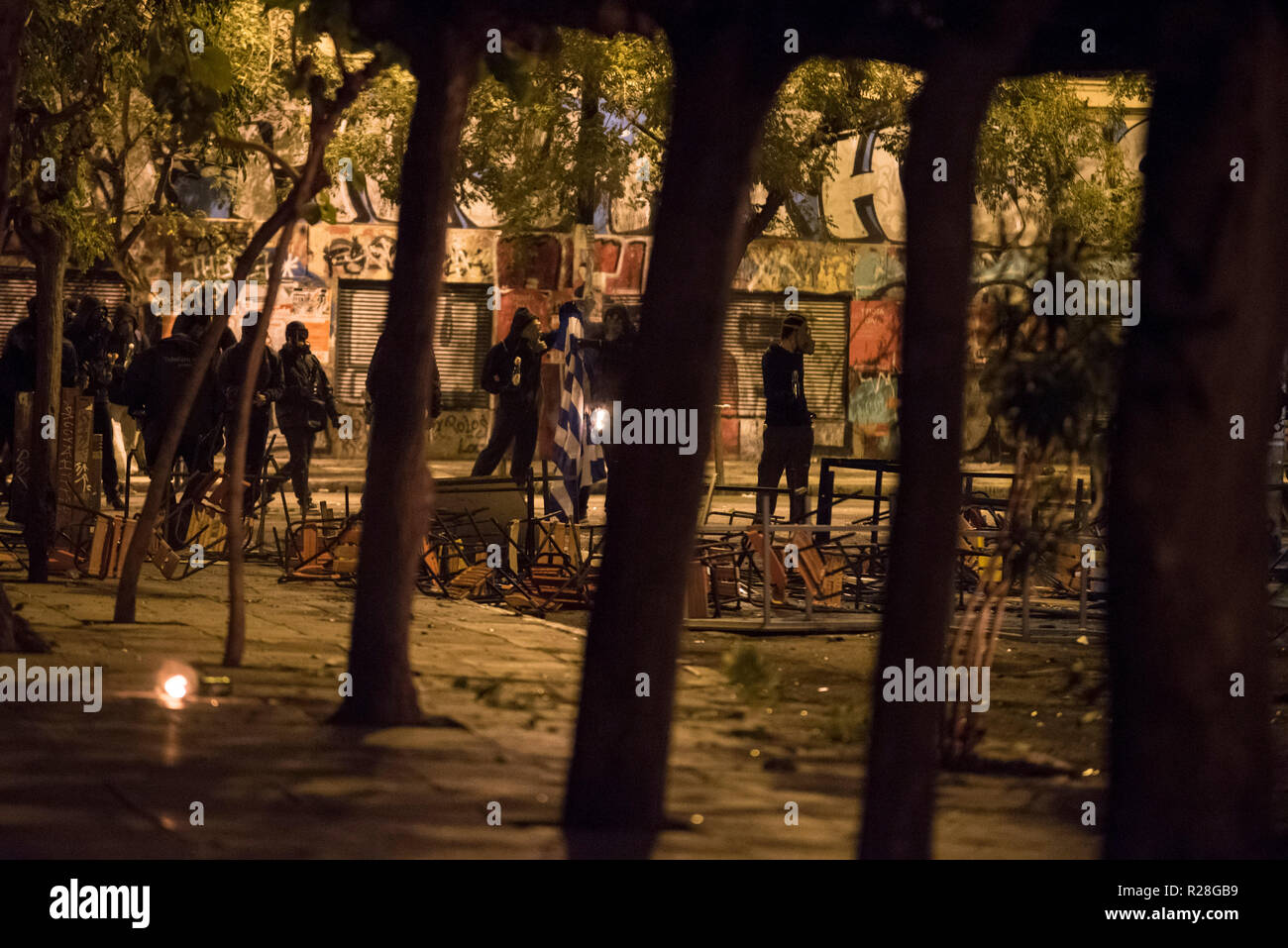 Protesters clash with riot police, following a massive demonstration to commemorate the Athens Polytechnic uprising against the junta in 1973. Stock Photo