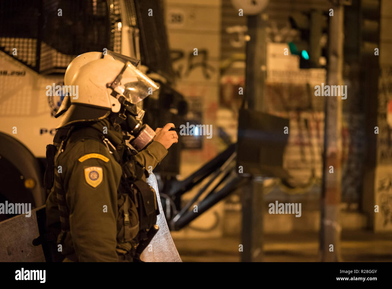 Protesters clash with riot police, following a massive demonstration to commemorate the Athens Polytechnic uprising against the junta in 1973. Stock Photo