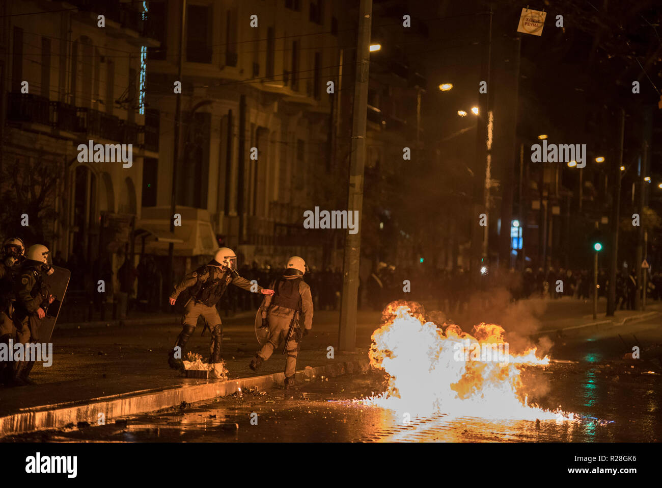 Protesters clash with riot police, following a massive demonstration to commemorate the Athens Polytechnic uprising against the junta in 1973. Stock Photo