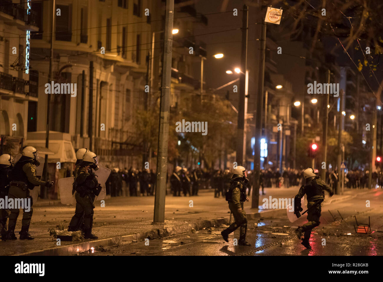 Protesters clash with riot police, following a massive demonstration to commemorate the Athens Polytechnic uprising against the junta in 1973. Stock Photo