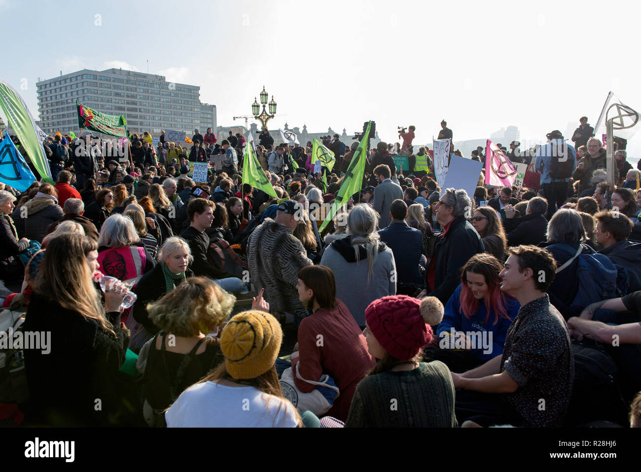 Environmental activist sit on the ground as they block the Westminster