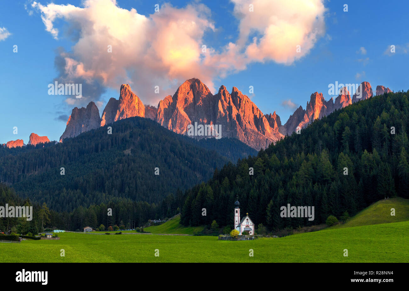 St. Johann (San Giovanni in Italian) chapel in Val di Funes with the Dolomites Odle group on background. Northern Italy. Stock Photo