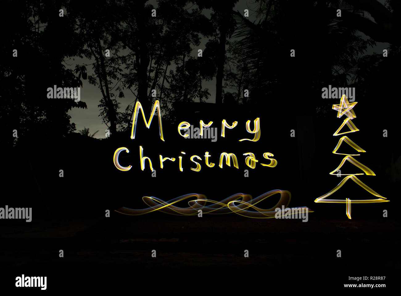 Luxury greetings merry Christmas. Hand writing with Light painting art work Stock Photo