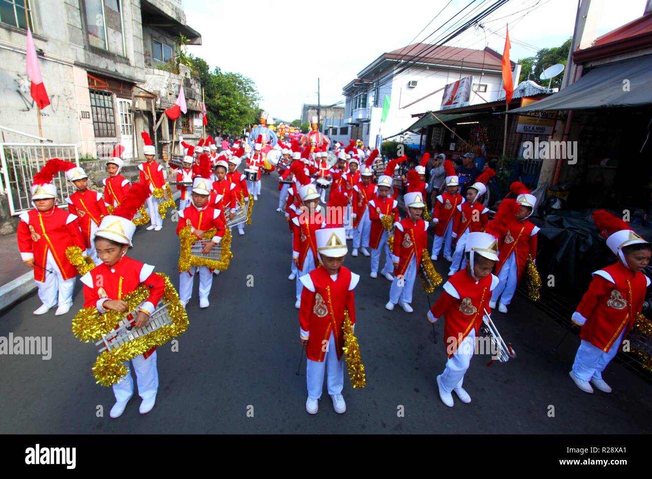 Kids musicians performed during the Higantes (Giant) effigy marches on the streets town of Angono province of Rizal on November 18, 2018. Higantes (Giant) Festival is celebrated November in the city of Angono, Province of Rizal in the Philippines to honor San Clemente, the patron saint of fishermen. The festival features a parade of hundreds of higantes, papier-mâché giants. Higantes (Giant) are puppets rendered as man or woman in various costumes; their face gives a commanding look, their hands on the waist. (Photo by Gregorio B. Dantes Jr./Pacific Press) Stock Photo