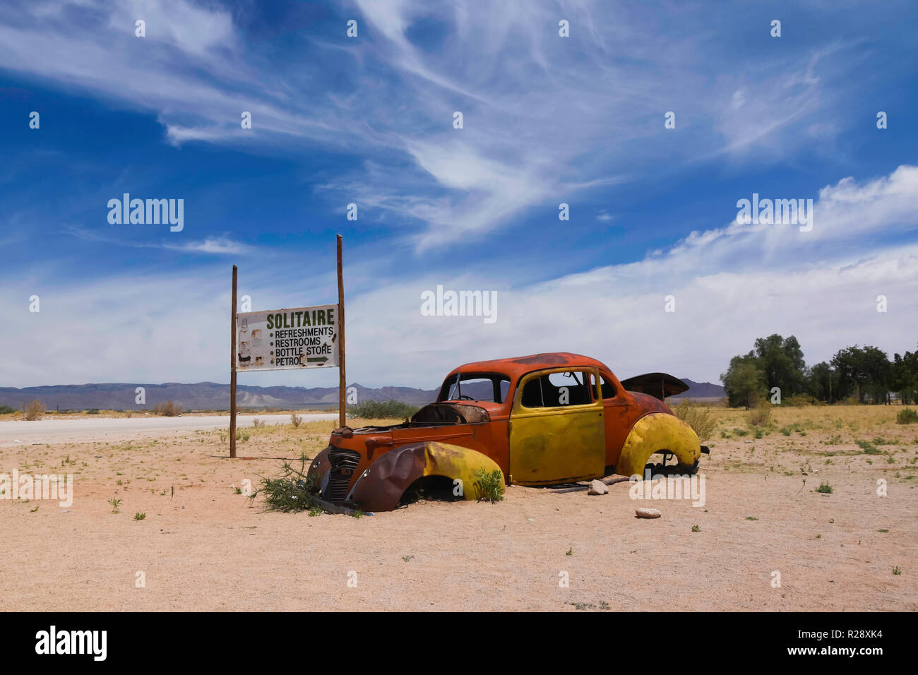 Wrecked cars lie abandoned in the desert surrounding Solitaire in Namibia. Stock Photo