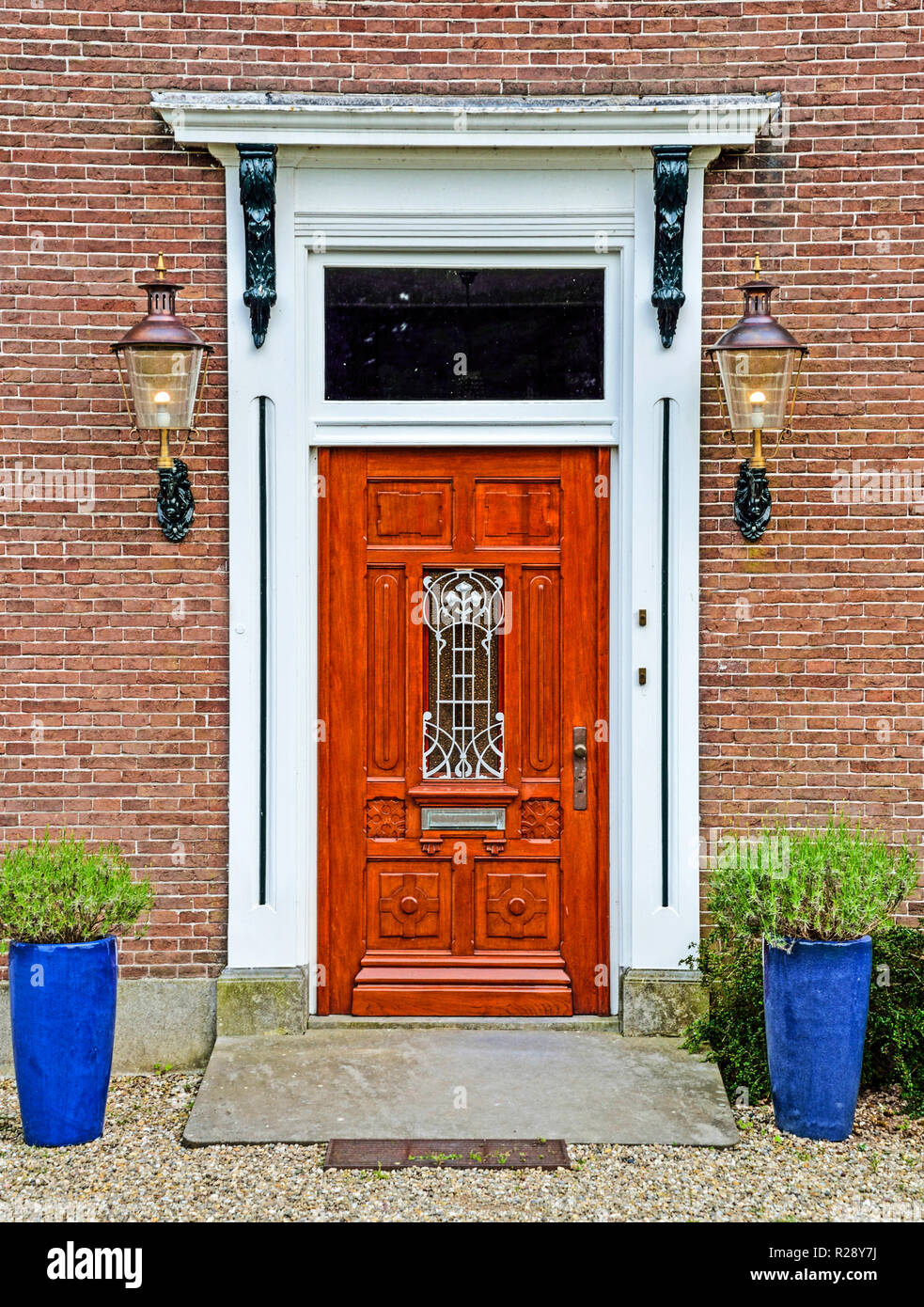 Decorative door with two blue flower pots Stock Photo - Alamy
