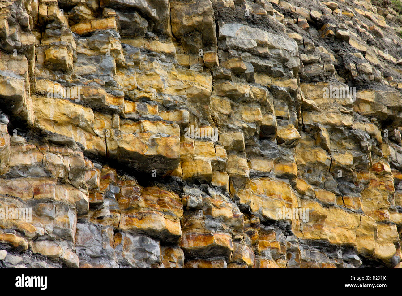 Layers of rock strata in the unstable cliff face at Nash Point, South Wales, UK Stock Photo